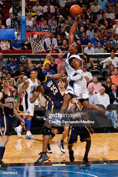 Dwight Howard of the Orlando Magic goes for a dunk after grabbing an alley-oop pass against the Indiana Pacers during the game on December 14, 2009...