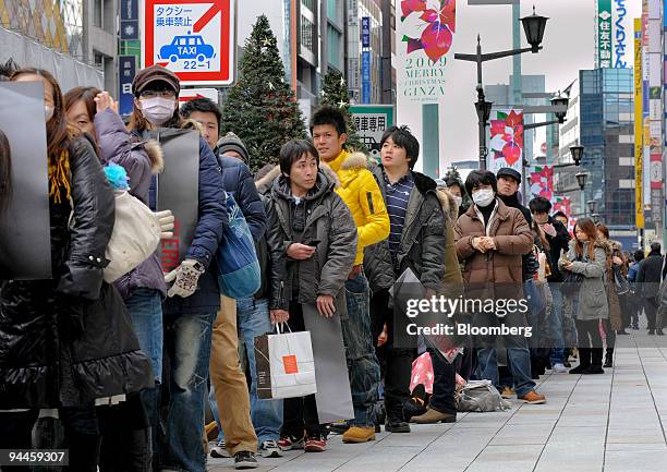 Customers wait in line for the opening of the first Abercrombie & Fitch Co. Shop in Tokyo, Japan, on Tuesday, Dec. 15, 2009. Abercrombie & Fitch Co....