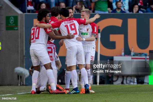 Sergio Duvan Cordova Lezama of Augsburg celebrates after scoring his team`s first goal with team mates during the Bundesliga match between FC...