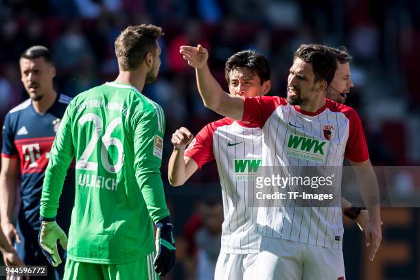 Goalkeeper Sven Ulreich of Muenchen and Rani Khedira of Augsburg argue during the Bundesliga match between FC Augsburg and FC Bayern Muenchen at...