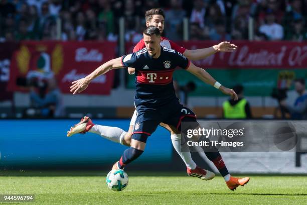 Sandro Wagner of Muenchen and Rani Khedira of Augsburg battle for the ball during the Bundesliga match between FC Augsburg and FC Bayern Muenchen at...