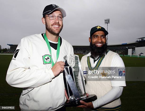 Daniel Vettori of New Zealand shares the National Bank Series Test trophy with Mohammad Yousuf after drawing the Third Test match between New Zealand...