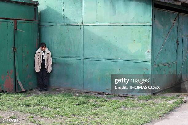 Picture taken on November 25, 2009 shows a disabled and orphaned Romanian adult during a break at the Targu Jiu orphanage southwestern Romania, after...