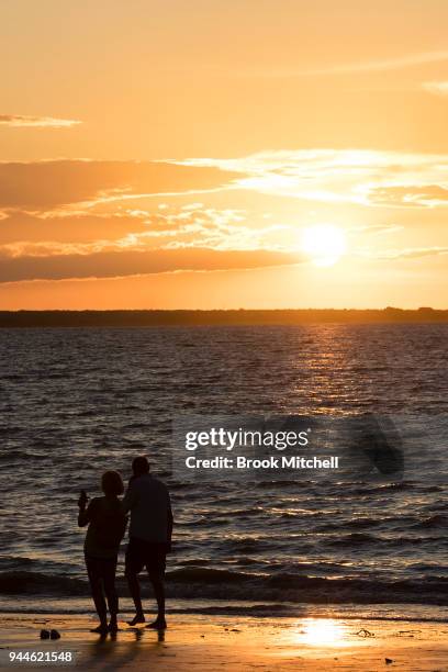 People enjoy the sunset on Mindil Beach on April 8, 2018 in Darwin, Australia. Darwin is the capital of the Northern Territory. It is the smallest...