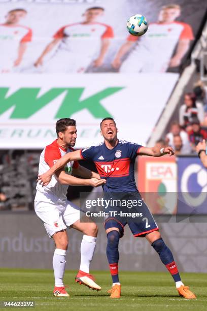 Rani Khedira of Augsburg and Sandro Wagner of Muenchen battle for the ball during the Bundesliga match between FC Augsburg and FC Bayern Muenchen at...