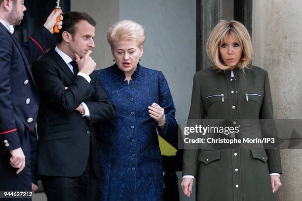 French president Emmanuel Macron and his wife Brigitte Macron leaves the Elysee palace with Lituania president Dalia Grybauskaite on April 9, 2018 in...