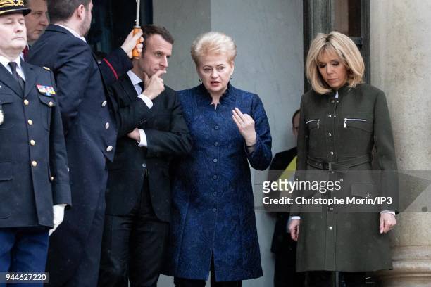 French president Emmanuel Macron and his wife Brigitte Macron leaves the Elysee palace with Lituania president Dalia Grybauskaite on April 9, 2018 in...