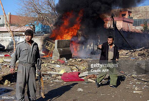 Afghan security personnel stand at the site of a suicide attack near a guesthouse in Kabul on December 15, 2009. A suspected suicide attack has...