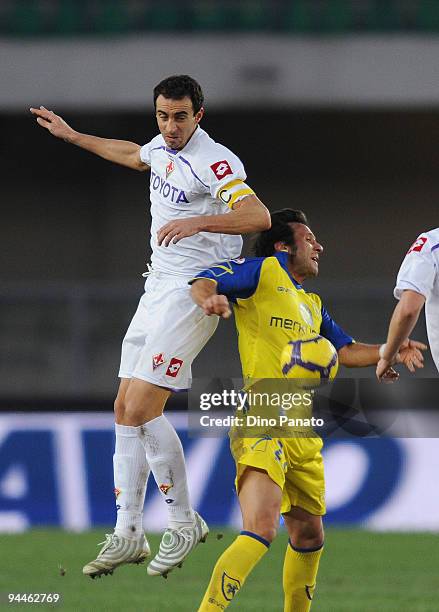 Elvis Abruscato of Chievo Verona competes in the air with Dario Dainelli of Fiorentina during the Serie A match between Chievo and Fiorentina at...