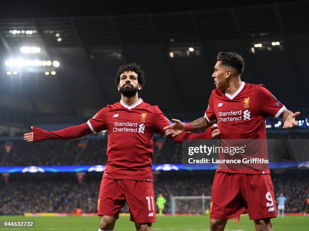 Mohamed Salah of Liverpool celebrates scoring the first goal with Roberto Firmino during the Quarter Final Second Leg match between Manchester City...