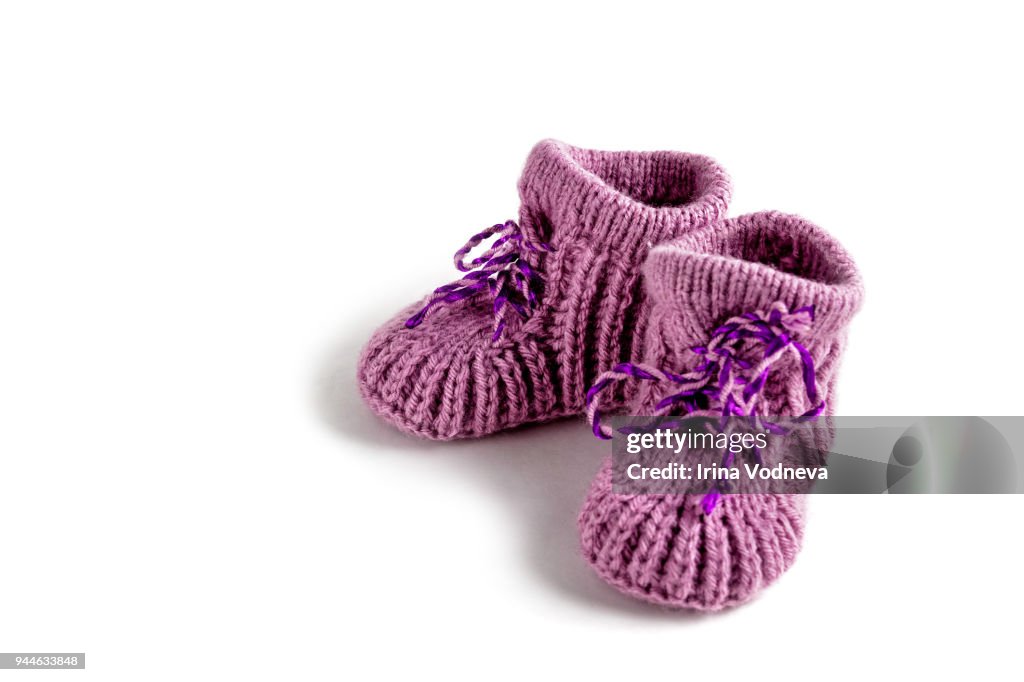 Baby booties on white background. Knitted.