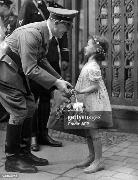 Picture dated 1937 shows German Chancellor and Nazi Dictator Adolf Hitler receiving flowers from a little girl. AFP PHOTO