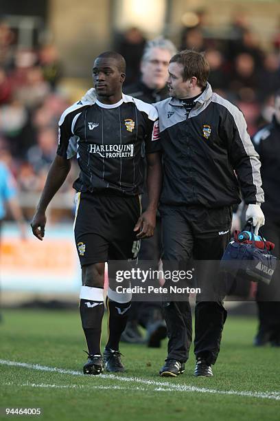 Anthony Griffith of Port Vale is helped from the pitch by physio John Bower after being knocked unconscious during the Coca Cola League Two Match...