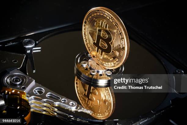 Berlin, Germany In this photo illustration a coin of the crypto currency Bitcoin stands on a hard disk on April 10, 2018 in Berlin, Germany.