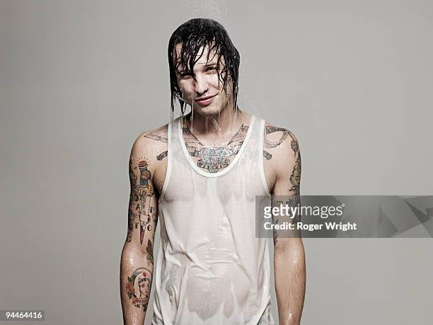 young man being splached by water - wet hair stock pictures, royalty-free photos & images