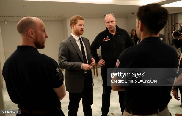 Britain's Prince Harry meets members of the British 'Walk of America' team during its launch at a hotel in London on April 11, 2018. Prince Harry...