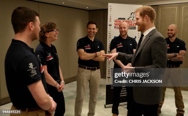 Britain's Prince Harry meets members of the British 'Walk of America' team during its launch at a hotel in London on April 11, 2018. Prince Harry...
