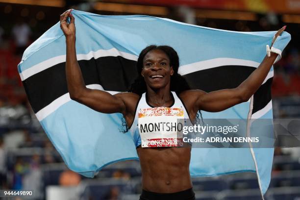 Botswana's Amantle Montsho holds her national flag after winning the athletics women's 400m final during the 2018 Gold Coast Commonwealth Games at...