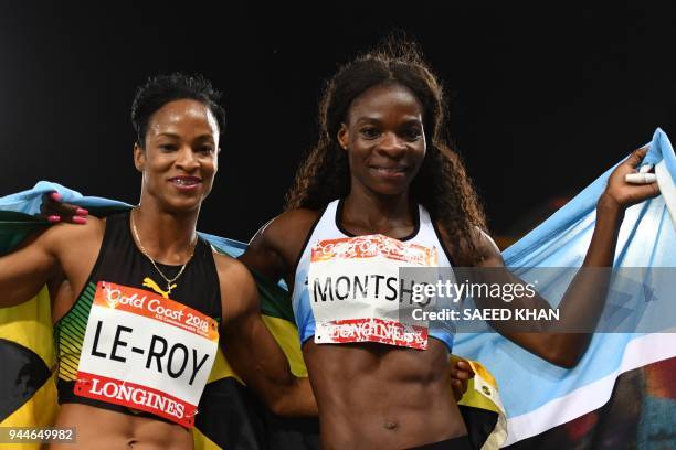 Botswana's Amantle Montsho and Jamaica's Anastasia Le-Roy celebrate with flag after winning the athletics women's 400m final during the 2018 Gold...