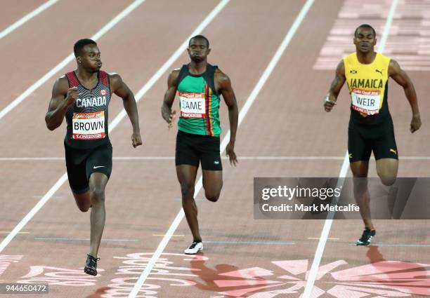 Aaron Brown of Canada, Sydney Siame of Zambia and Warren Weir of Jamaica compete in the Men's 200 metres semi finals during athletics on day seven of...