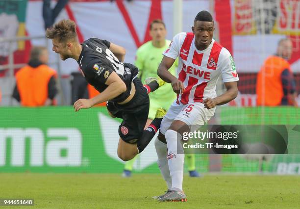 Alexander Hack of Mainz and Jhon Cordoba of Koeln battle for the ball during the Bundesliga match between 1. FC Koeln and 1. FSV Mainz 05 at...