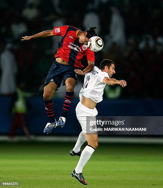 Luis Velasquez of Mexico's Atlante FC competes with Daniel Koprivic of Auckland City of New Zealand during their 2009 FIFA Club World Cup...