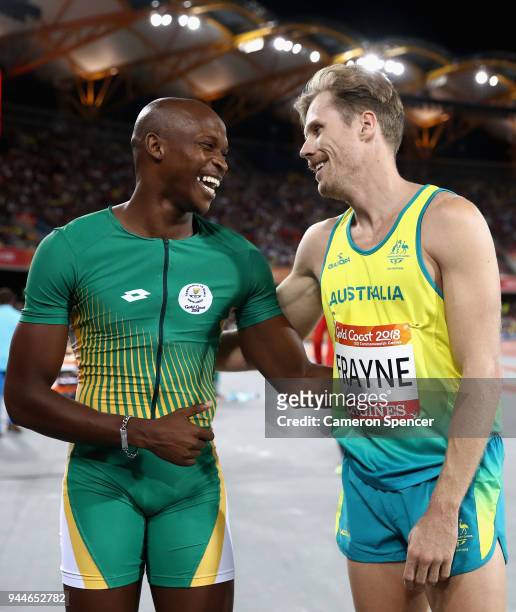 Luvo Manyonga of South Africa celebrates winning gold with silver medalist Henry Frayne of Australia in the Men's Long Jump final during athletics on...