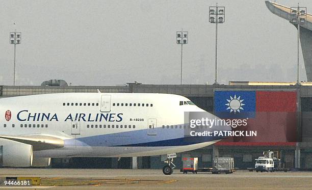 To go with story Taiwan-China-aviation-company-CAL by Benjamin Yeh In a picture taken on December 11 a China Airlines plane taxis on the tarmac at...