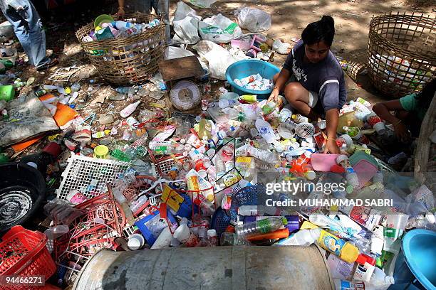 Picture taken on December 12, 2009 shows a Thai woman sorting through watse plastic at a factory in Thailand's southern province of Yala. Developing...