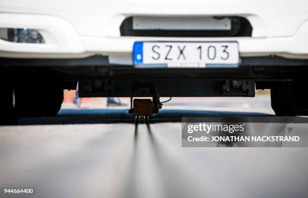 An all-electric truck is attached to the first "eRoad" of its kind, an approximately two-kilometer-long electrified road on April 11, 2018 at Arlanda...