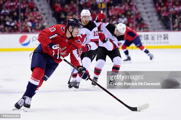 Jakub Vrana of the Washington Capitals skates with the puck against Jimmy Hayes of the New Jersey Devils in the first period at Capital One Arena on...