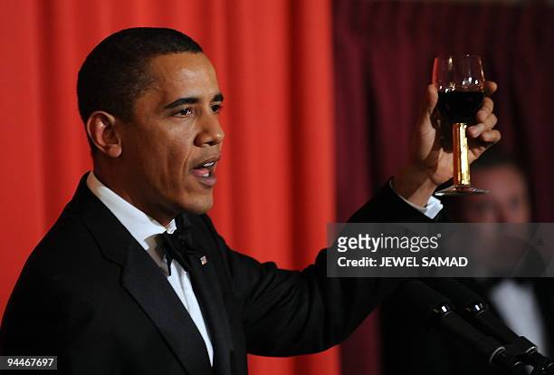 President and Nobel Peace Prize laureate Barack Obama raises his glass as he makes a toast during the Nobel Banquet in Oslo on December 10, 2009....