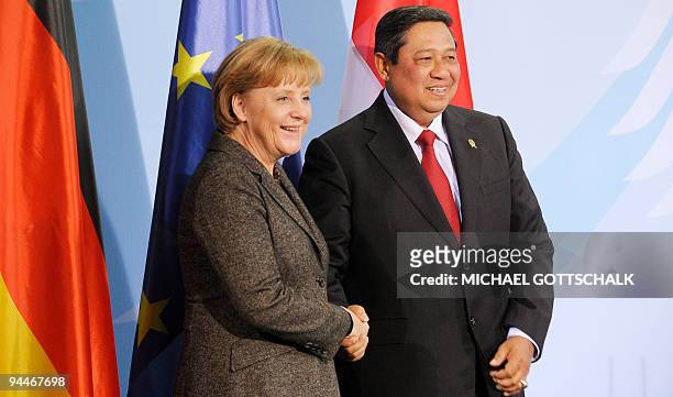 German Chancellor Angela Merkel and Indonesian President Susilo Bambang Yudhoyono shake hands following a press conference after they helds talks...