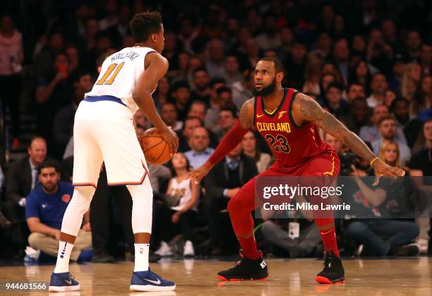 LeBron James of the Cleveland Cavaliers defends Frank Ntilikina of the New York Knicks in the first half at Madison Square Garden on April 9, 2018 in...