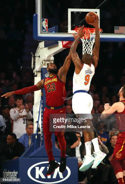 Kyle O'Quinn of the New York Knicks goes up for a dunk against LeBron James of the Cleveland Cavaliers in the first half at Madison Square Garden on...