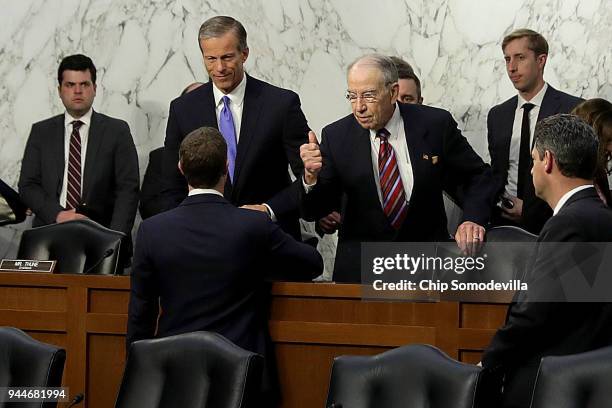 Facebook co-founder, Chairman and CEO Mark Zuckerberg shakes hands With Senate Commerce Committee Chairman John Thune and Judiciary Committee...