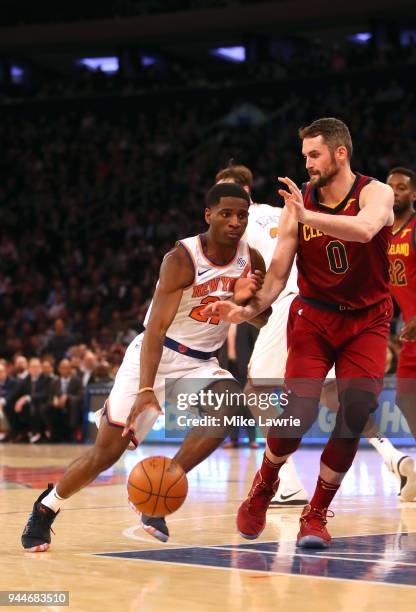Damyean Dotson of the New York Knicks handles the ball against Kevin Love of the Cleveland Cavaliers in the fourth quarter at Madison Square Garden...