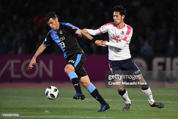 Eduardo of Kawasaki Frontale and Kenyu Sugimoto of Cerezo Osaka compete for the ball during the J.League J1 match between Kawasaki Frontale and...