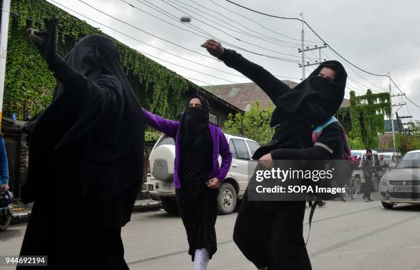 Kashmiri female student protester throw stones towards government forces during clashes in Srinagar, Indian administered Kashmir. Four civilians were...