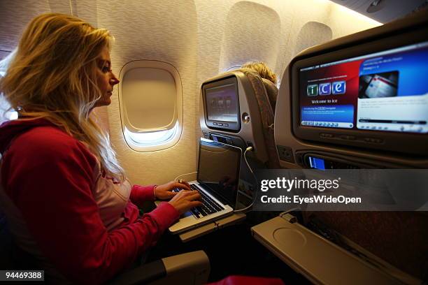 Woman is working with a notebook on board of a Emirates Airline passenger jet on December 08, 2009 in Trivandrum, India. Since some month its new...