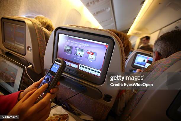 Woman is working an makes a telephone call on board of a Emirates Airline passenger jet on December 08, 2009 in Trivandrum, India. Since some month...