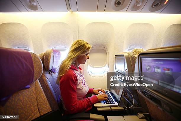 Woman is working with a notebook on board of a Emirates Airline passenger jet on December 08, 2009 in Trivandrum, India. Since some month its new...