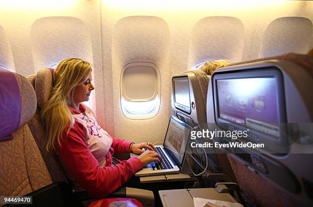 Woman is working with a notebook on board of a Emirates Airline passenger jet on December 08, 2009 in Trivandrum, India. Since some month its new...