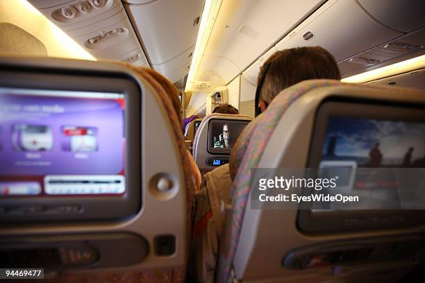 Passenger is watching a movie on board of a Emirates Airline passenger jet on December 08, 2009 in Trivandrum, India. Since some month its new that...