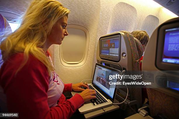 Woman is working with a notebook on board of a Emirates Airline passenger jet on December 08, 2009 in Trivandrum, India. Since some month its new...