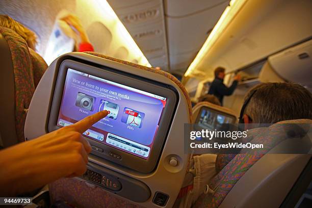 Passenger is watching a movie on board of a Emirates Airline passenger jet on December 08, 2009 in Trivandrum, India. Since some month its new that...