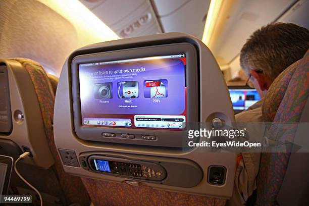 Passenger is watching a movie on board of a Emirates Airline passenger jet on December 08, 2009 in Trivandrum, India. Since some month its new that...