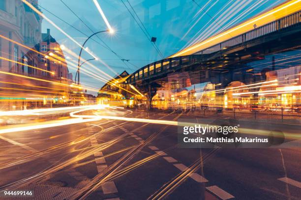 modern creative zoom rush hour night street szene in berlin with traffic lights - berlin stock-fotos und bilder