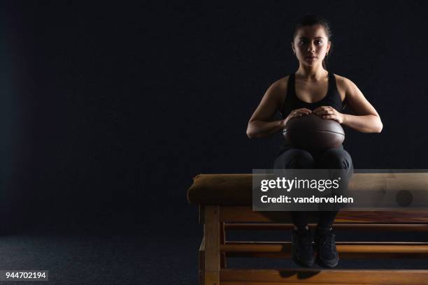 athlete sitting on an old vaulting horse - vandervelden stock pictures, royalty-free photos & images