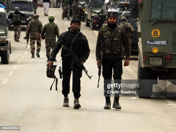 Indian army soldiers patrol near the gun-battle site in Khudwani area of south Kashmir's Kulgam some 60 kilometers from Srinagar the summer capital...